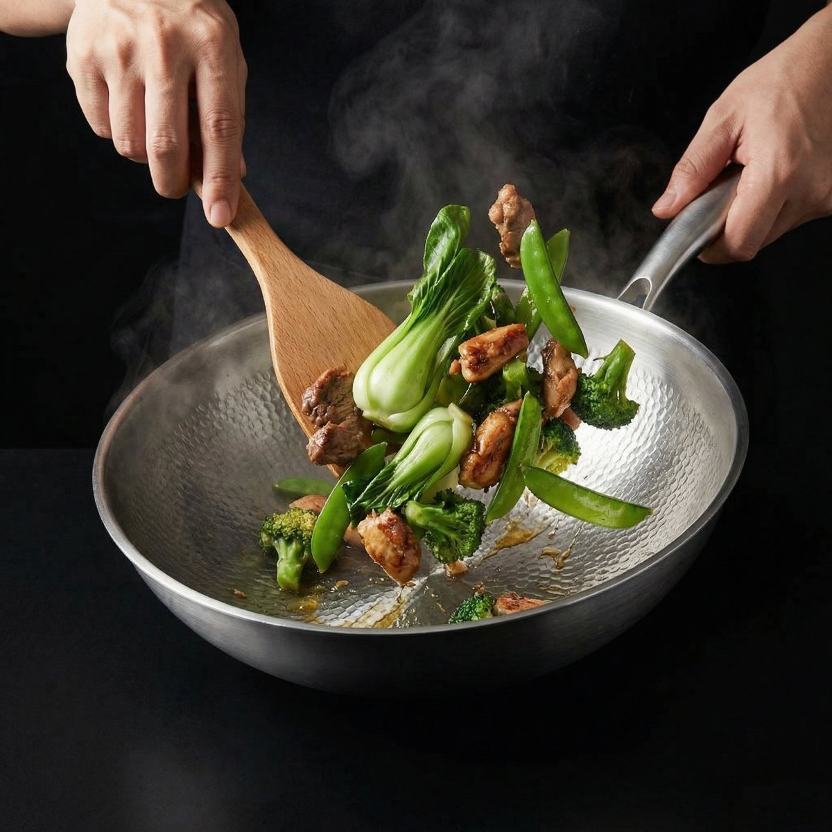 Cook stirring pak choi, broccoli, mangetout and chicken in the wok with a wooden spatula while holding the handle. 7