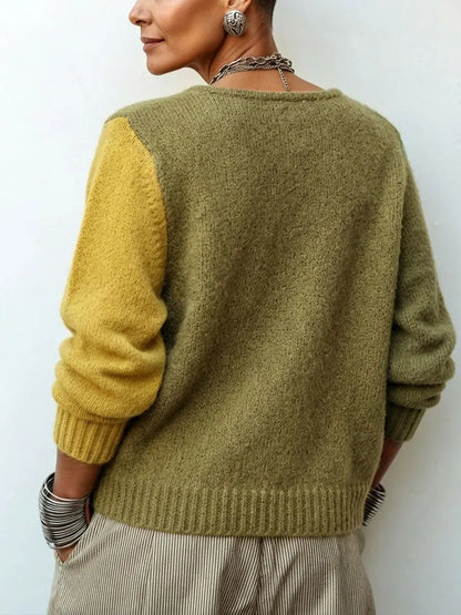 Back view of the knit sweater, showing a plain olive back, one mustard sleeve and ribbed cuffs and hem. 3