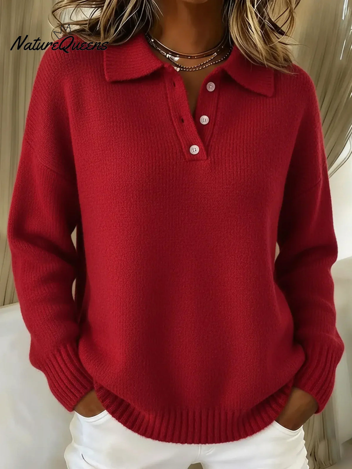 Model wearing the knitted polo jumper in bright red, with a button placket, soft ribbed collar and drop shoulders. 3