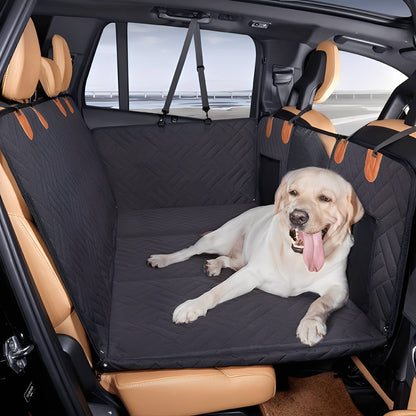 Black quilted seat extender fitted across the back seat of an SUV, with a pale Labrador lying on it, tongue out. 1