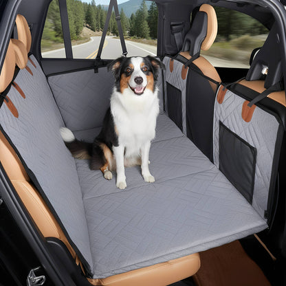 Grey version of the seat extender with a black, white and tan collie-type dog sitting upright on it during a drive. 11