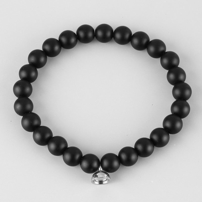 Flat lay of the matte black bead bracelet with a small silver magnetic clasp 2