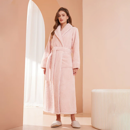 Model in a soft pink fleece robe with a shawl collar and long tie belt, in a peach room 5