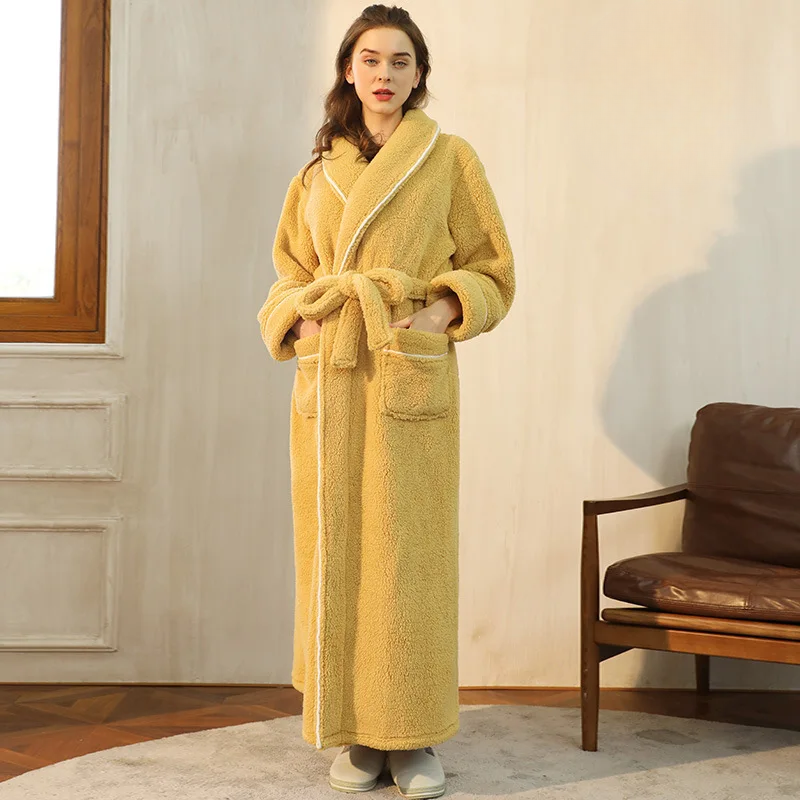 Model in a mustard yellow fleece robe with white piping, hands in pockets, belt tied in a bow 8