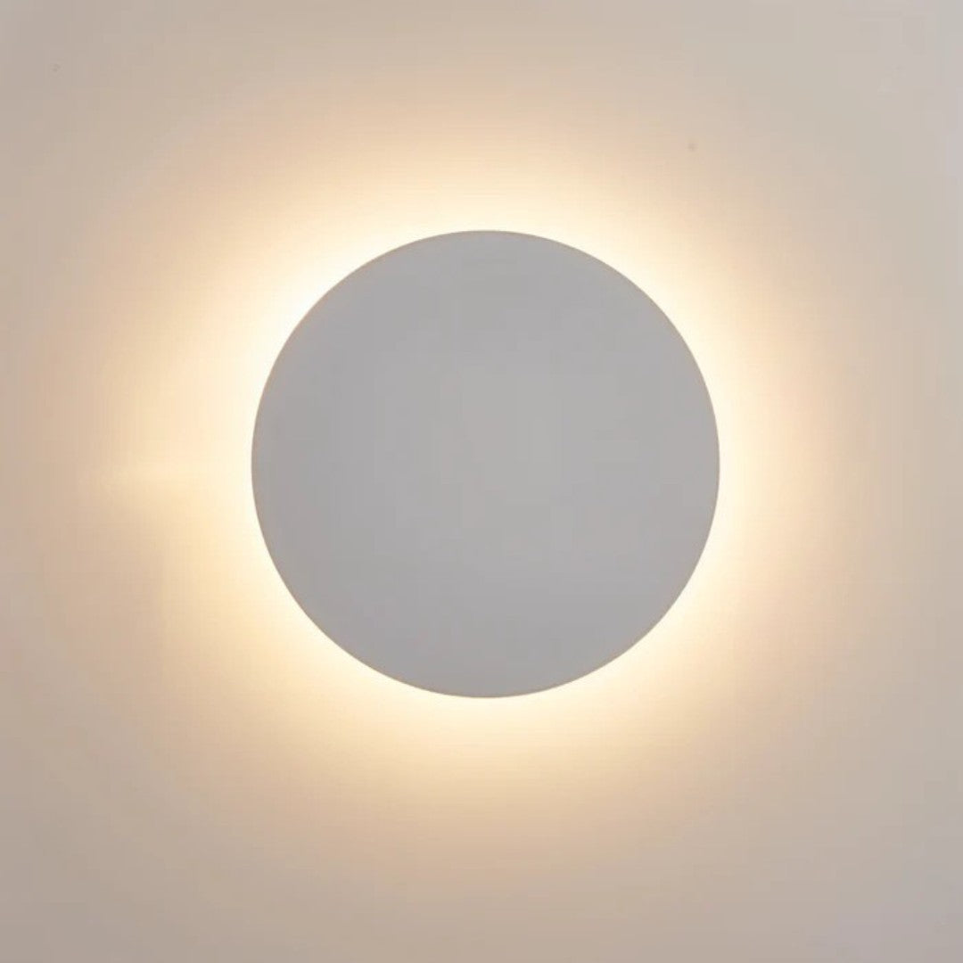 Close-up of the white disc lit, with a soft warm halo glowing around its edge 3