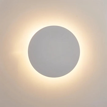 Close-up of the white disc lit, with a soft warm halo glowing around its edge 3
