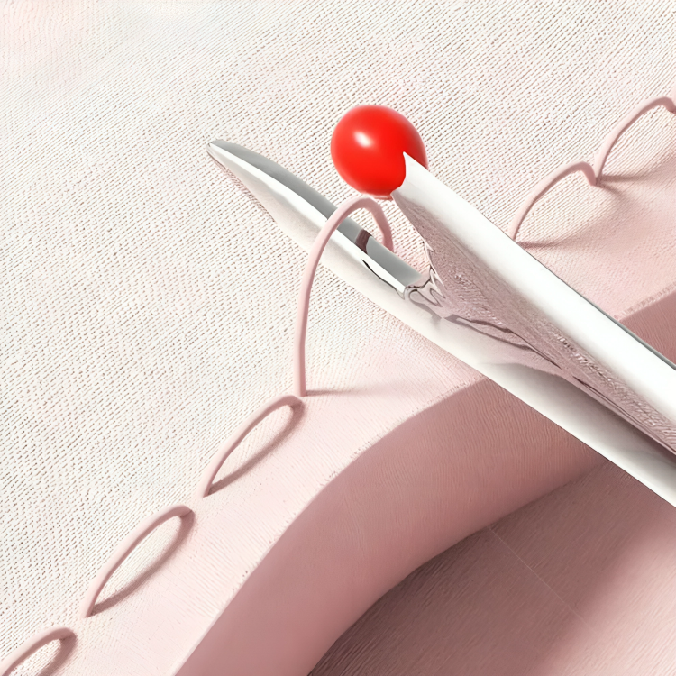 Seam ripper with red ball tip lifting loops of pink stitching on pale pink fabric 4
