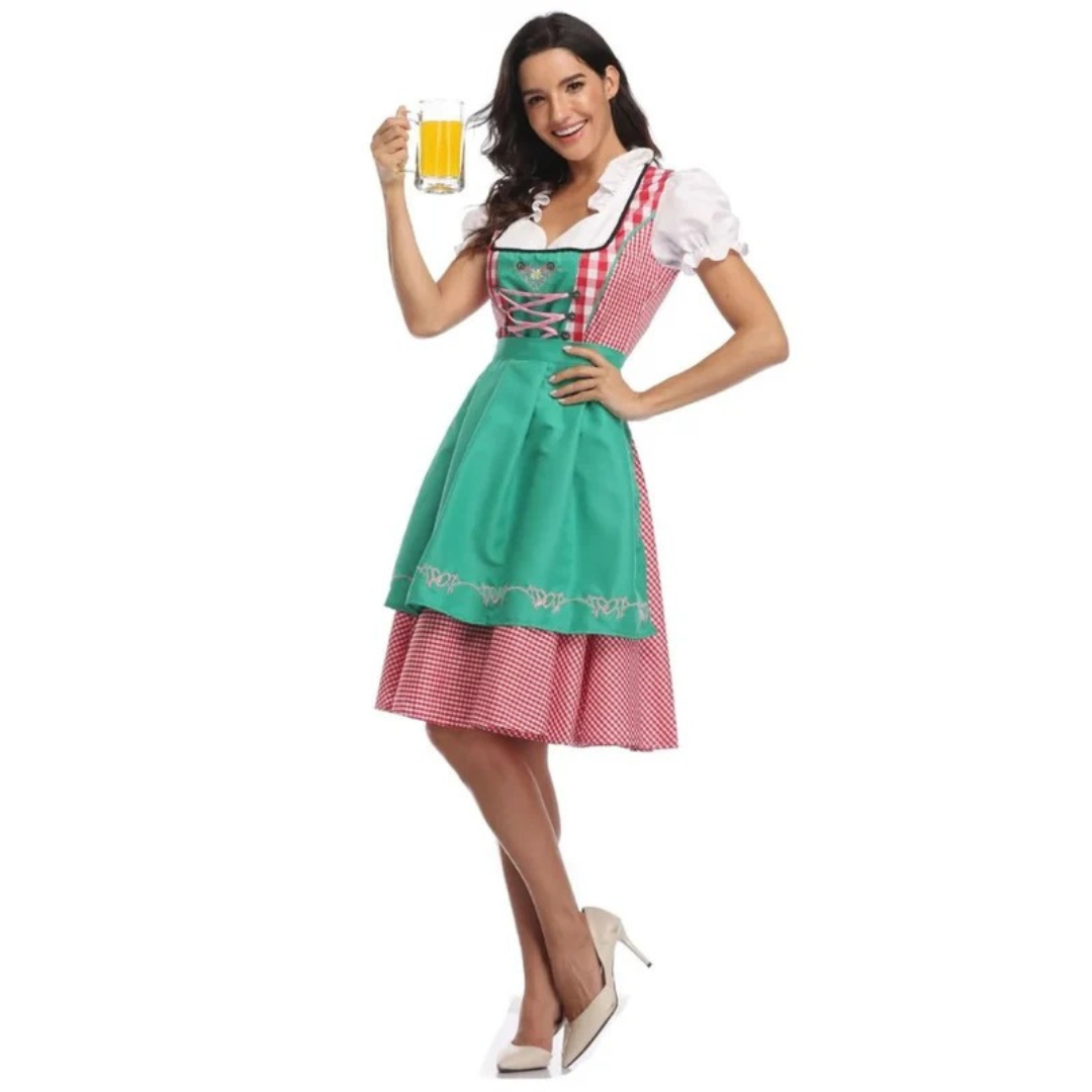 Full-length model shot of the red gingham dirndl with a green embroidered apron, one hand raised holding a beer glass. 4