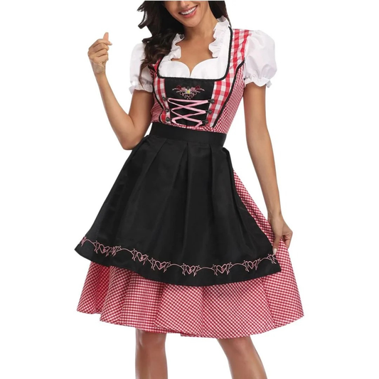 Model in the red gingham dirndl with black embroidered apron, pink lace-up bodice and puffed white sleeves, holding the skirt out. 1