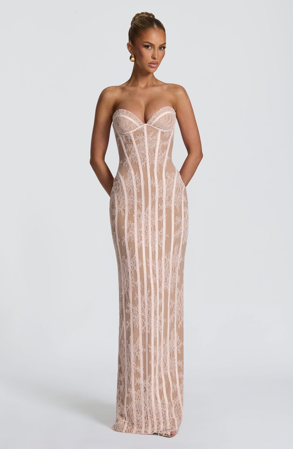 Front view of the blush pink lace corset dress with a nude lining, sweetheart bustier and vertical boning. 13