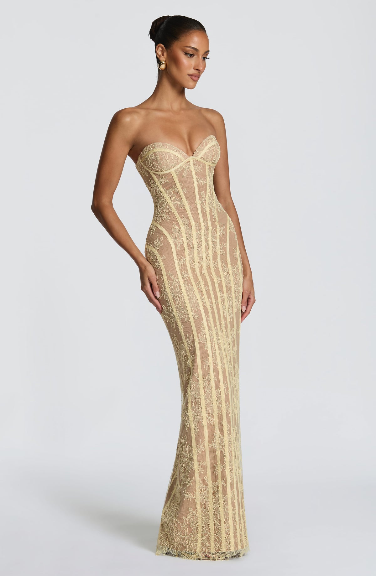 Angled view of the pale yellow floral lace gown, showing the strapless sweetheart neckline and fitted column skirt. 19