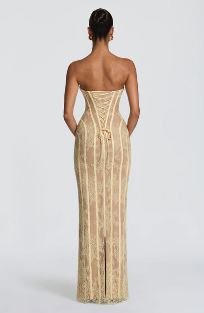 Back view of the pale yellow lace dress, showing the corset lacing, ribbon ties and slit in the skirt. 18