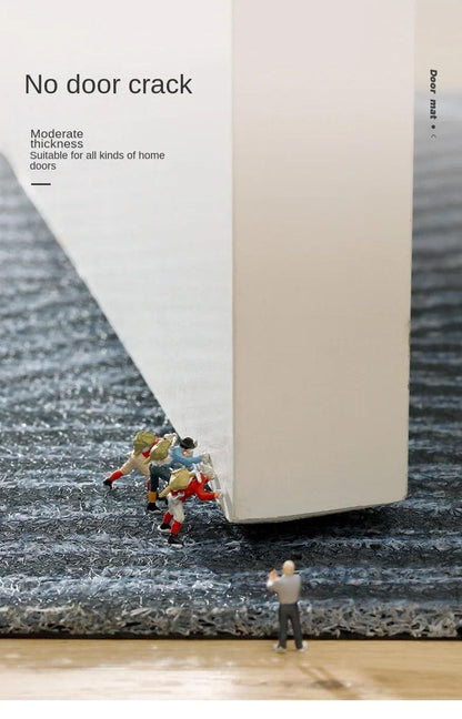 Miniature figures pushing a white door above the mat's pile, illustrating that it is thin enough to clear doors 10