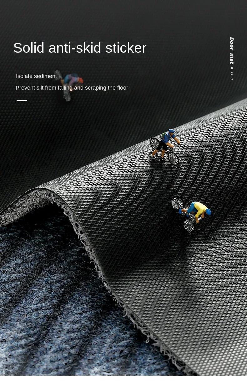 Mat edge folded back to show the black diamond-textured anti-slip underside, with tiny cyclist figures riding on it 11