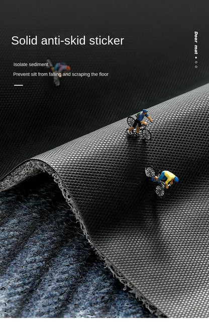 Mat edge folded back to show the black diamond-textured anti-slip underside, with tiny cyclist figures riding on it 11