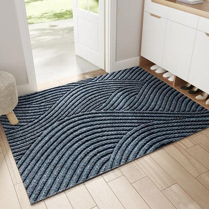 Blue-grey mat with flowing wave-like ridges laid inside a doorway next to a shoe cabinet 4