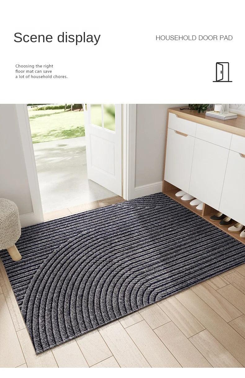 Dark grey mat with curved ridges in a bright hallway, shown as a household scene display 9