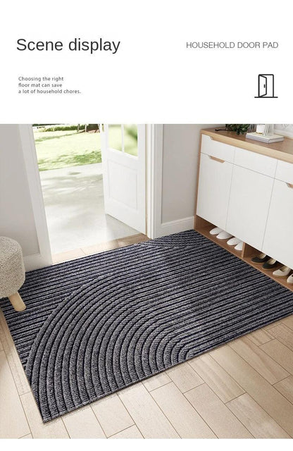Dark grey mat with curved ridges in a bright hallway, shown as a household scene display 9