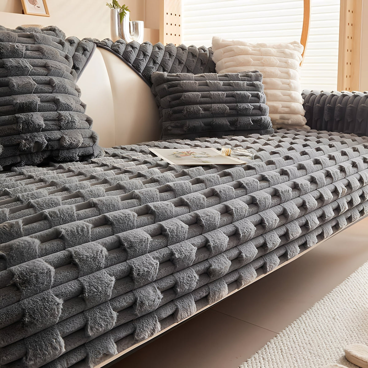 Dark grey version of the textured plush cover fitted on the sofa with matching dark cushions. 11