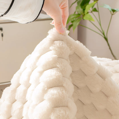 Hand lifting a corner of the cream cover to show the thick pile and the plain underside. 5