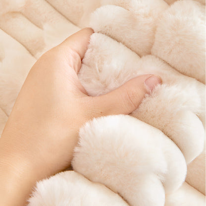 Hand gripping a fold of the cream plush fabric to show how thick, soft and fluffy the pile feels. 4