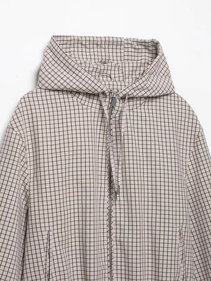Flat lay of the jacket's upper half, showing the hood, zip, drawstring cords with metal tips and side pockets. 7