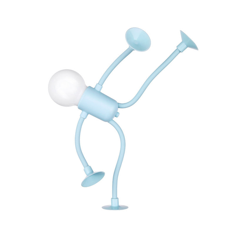 Light blue figure lamp bent into a one-handed handstand pose, its bulb head tilted sideways and suction cups on three limbs. 4