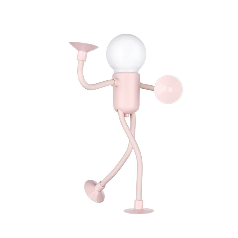 Pink figure lamp with a frosted bulb head, one arm raised, one leg lifted mid-stride and suction cups at every limb tip. 3