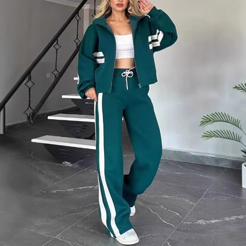 Model wearing the dark green set with white side stripes, jacket open over a white top and drawstring waist visible. 5