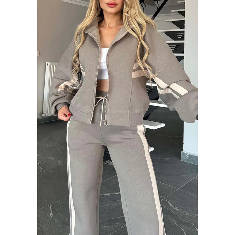 Close-up of the grey jacket with cream sleeve stripes, front zip, ribbed hem and drawstring waistband of the trousers. 7