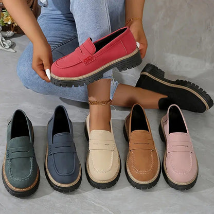 Six colour options of the loafers laid out together, with a model holding a red pair and a black pair beside her. 2