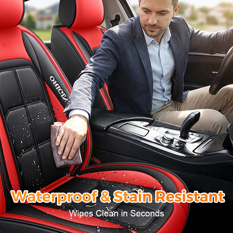 Man in a blazer wiping water droplets off a red and black seat cover with a cloth, showing the surface is easy to clean. 4