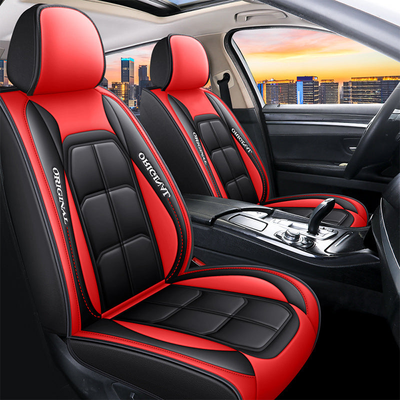 Front seat covers in black and red panels with raised stitched sections, fitted to both front seats of a car. 10