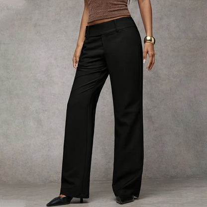 Black wide-leg trousers worn by a model, shown from a slight angle, with a brown top, gold cuff and black pointed shoes. 2