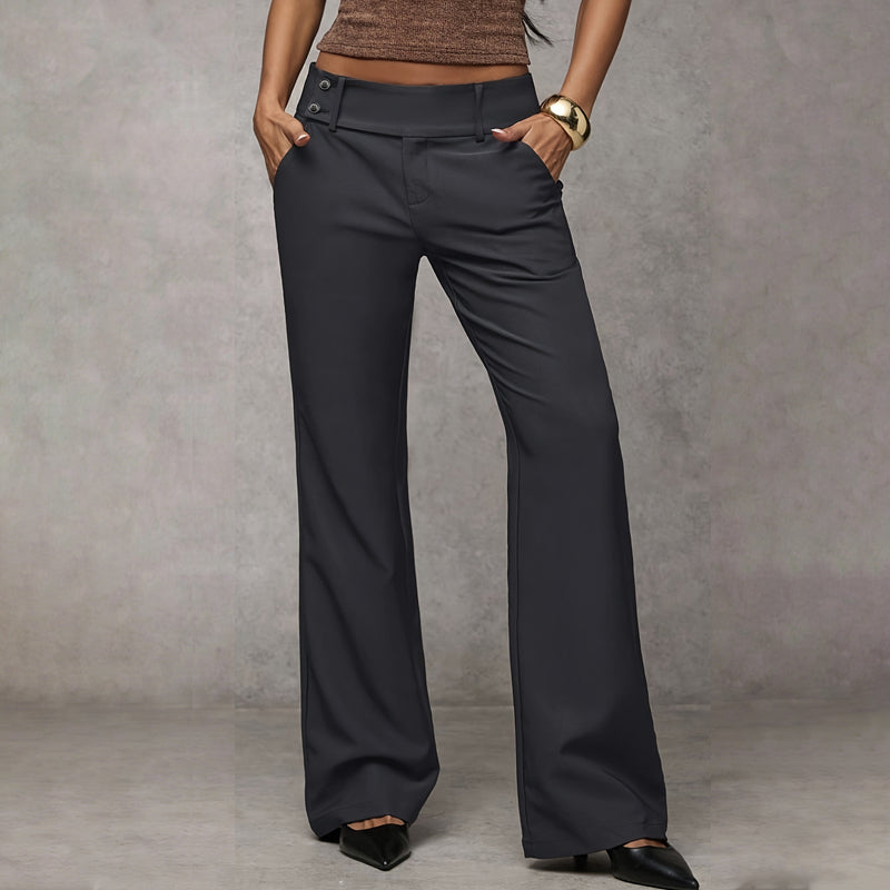 Model wearing dark grey wide-leg trousers with a double-button waistband, hands in pockets, front view with black pointed heels. 4