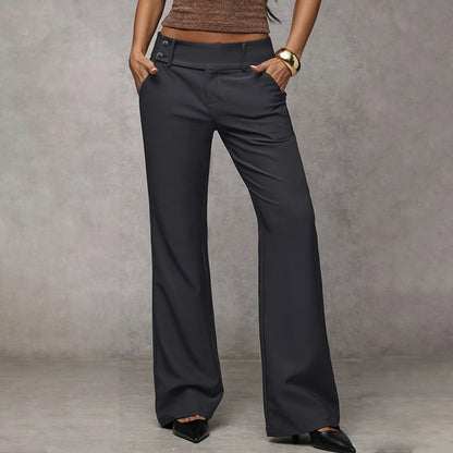 Model wearing dark grey wide-leg trousers with a double-button waistband, hands in pockets, front view with black pointed heels. 4