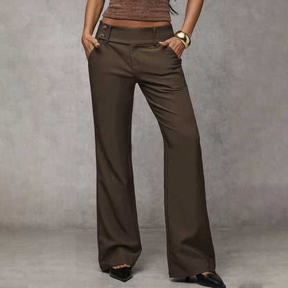 Model wearing olive-brown wide-leg trousers with button tabs at the waist, hands in pockets, with black pointed heels. 3