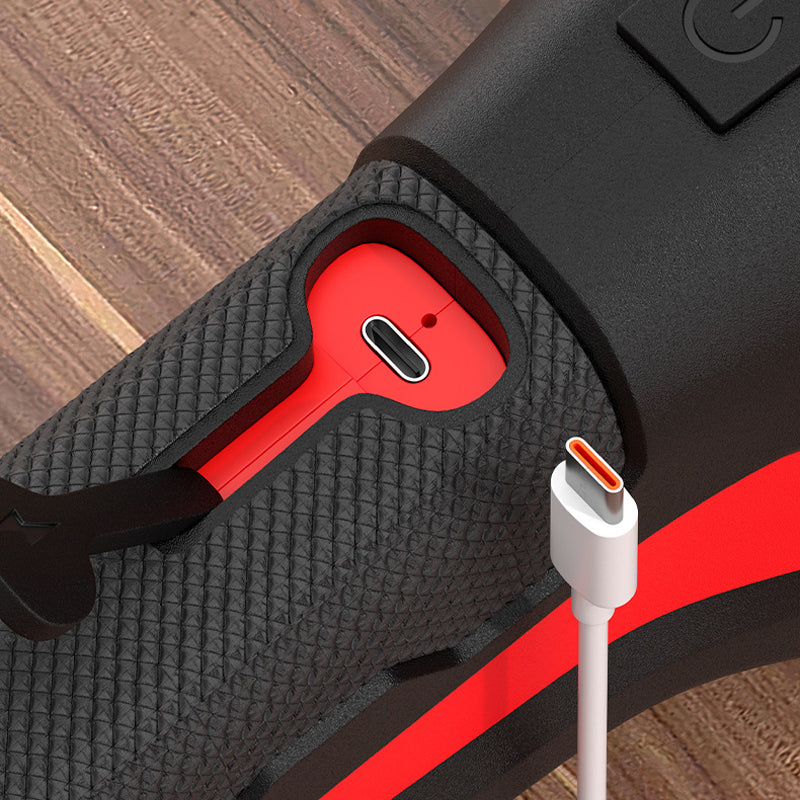 Close-up of the grip's open red port cover showing the USB-C charging socket, with a white USB-C cable beside it 5