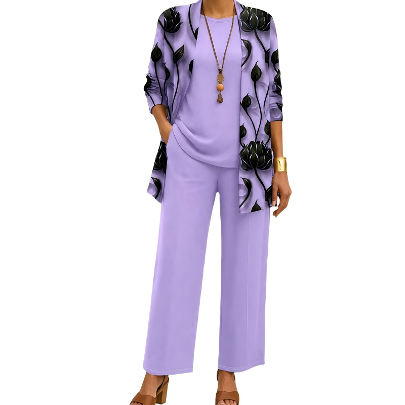 Model wearing the lilac set with a black lotus-print open cardigan, plain round-neck top and wide-leg trousers, with a beaded pendant necklace. 4