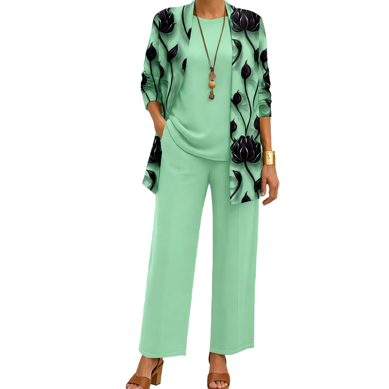 Model wearing the mint green set with a dark lotus-print open cardigan, matching plain top and wide-leg trousers, with a pendant necklace. 6