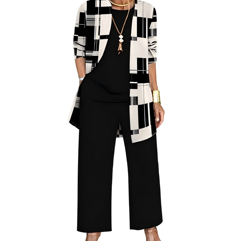 Model wearing the black and cream set, the cardigan in a geometric block and stripe print over a plain black top and wide-leg trousers. 8