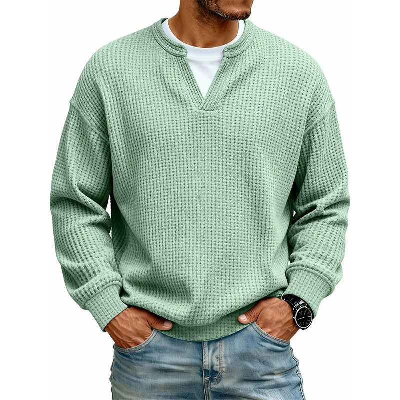 Front view of the waffle knit V-neck top in mint green, worn over a white tee with light jeans. 10