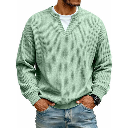 Front view of the waffle knit V-neck top in mint green, worn over a white tee with light jeans. 10