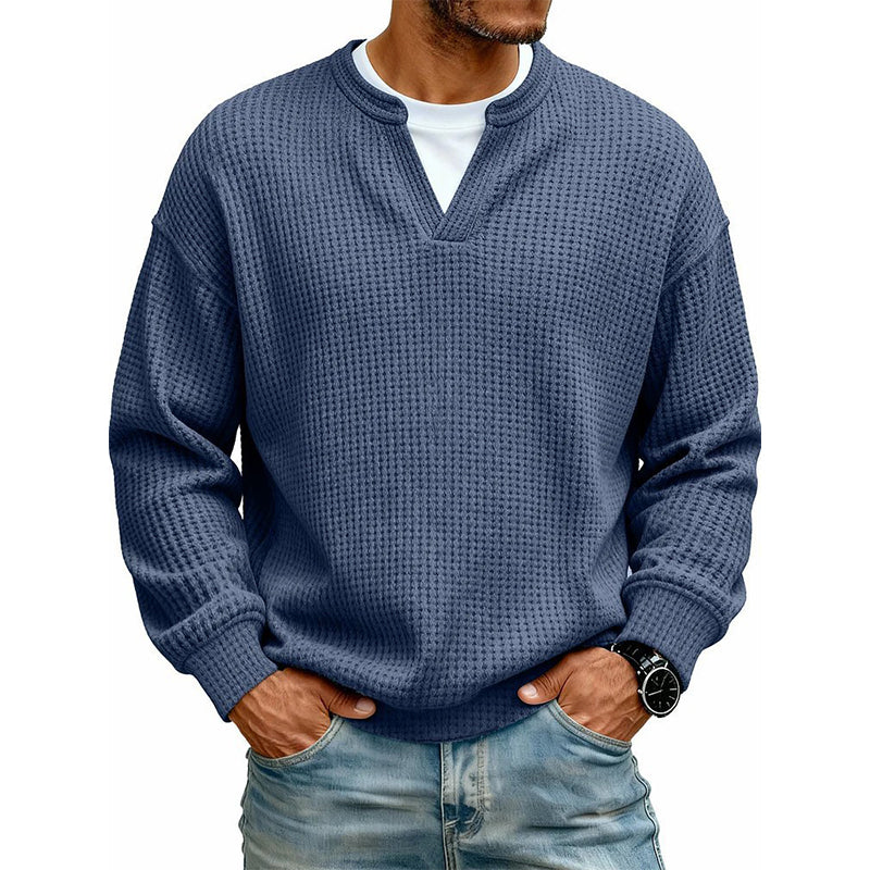 Front view of the waffle knit V-neck top in dark blue, worn over a white tee with light jeans. 13