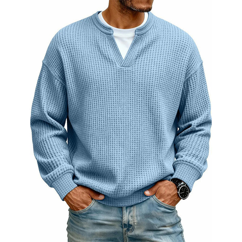 Front view of the waffle knit V-neck top in light blue, worn over a white tee with light jeans. 12