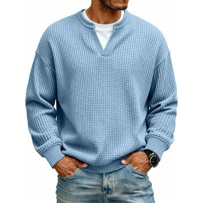 Front view of the waffle knit V-neck top in light blue, worn over a white tee with light jeans. 12