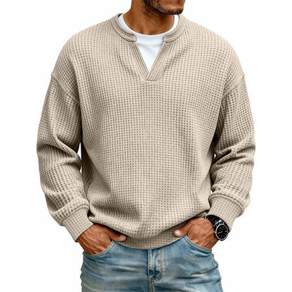 Front view of the waffle knit V-neck top in beige, worn over a white tee with light jeans. 11
