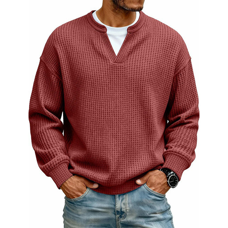 Front view of the waffle knit V-neck top in brick red, worn over a white tee with light jeans. 16
