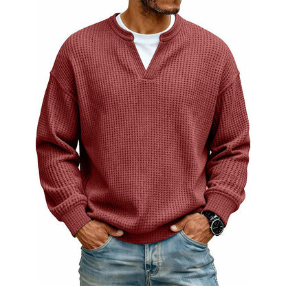 Front view of the waffle knit V-neck top in brick red, worn over a white tee with light jeans. 16