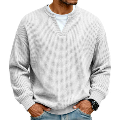 Front view of the waffle knit V-neck top in off-white, worn over a white tee with light jeans. 14